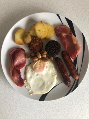 a plate of breakfast food with an egg and bacon at Seacrest B&B in Galway