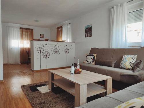 a living room with a couch and a coffee table at Apartman "Like at home" Jajce in Jajce