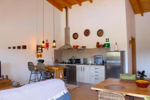 a kitchen with a refrigerator and a table at Quinta das Alfambras in Aljezur