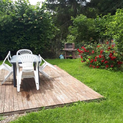 a table and chairs sitting on a wooden deck at Gite Seb et Delphine in Montauban-de-Picardie