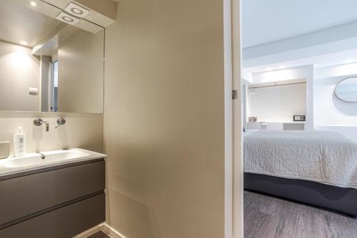 a small bathroom with a bed and a sink at Suite Brunate - by MyHomeInComo in Como