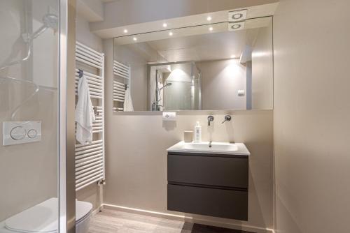a bathroom with a sink and a mirror at Suite Brunate - by MyHomeInComo in Como