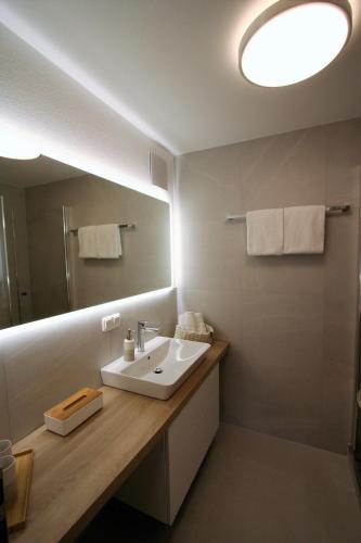 a bathroom with a sink and a mirror at Alpenflair Ferienwohnung 232 Talstation in Oberstdorf