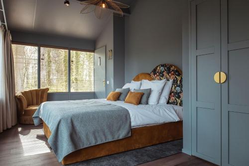 a bedroom with a large bed and a window at Boutique Hotel Restaurant BAL in Echteld