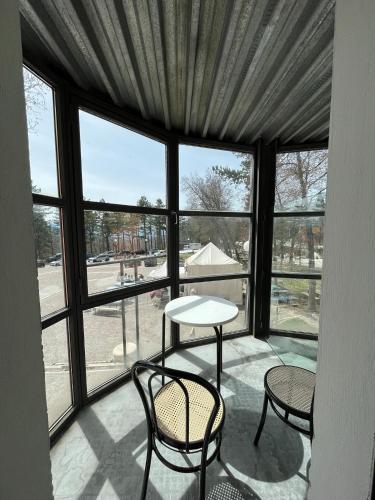 a room with a table and chairs and windows at Hotel Cristallo Gran Sasso in LʼAquila