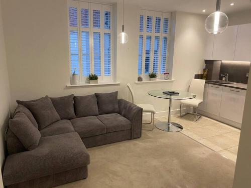 a living room with a couch and a table at UNRIVALLED LOCATION FIVE STAR WORCESTER APARTMENT in Worcester