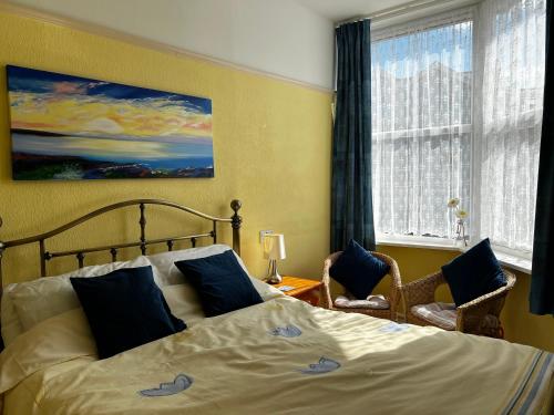 a bedroom with a large bed and a window at B&B Near the Sea in Paignton