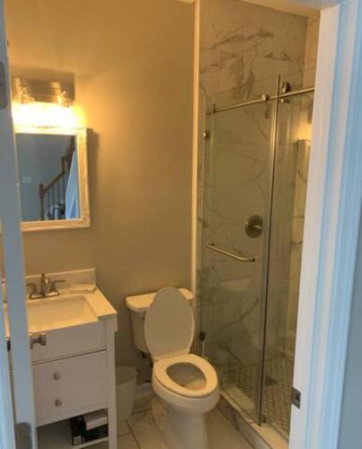 a bathroom with a toilet and a glass shower at Atlanta Unit 1 Room 3 - Cheerful Private Bedroom & Bathroom in Atlanta