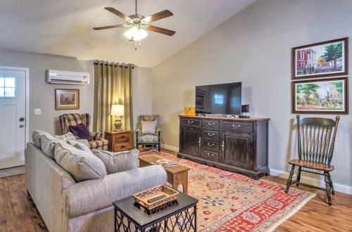 a living room with a couch and a flat screen tv at Pet-Friendly Brownsville Retreat with Porch! in Sloans Crossing