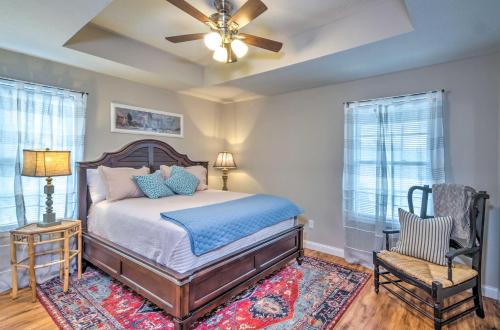 a bedroom with a bed and a ceiling fan at Pet-Friendly Brownsville Retreat with Porch! in Sloans Crossing