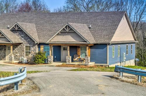 a home with a blue house with a roof at Pet-Friendly Brownsville Retreat with Porch! in Sloans Crossing