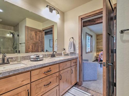 a bathroom with two sinks and a large mirror at Luxury Retreat Custom Mi-Wuk Village Cabin! in Mi-Wuk Village