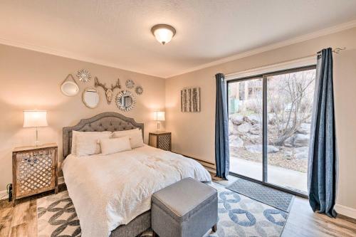 a bedroom with a bed and a large window at Chic Eden Condo with Pool Access Less Than 5 Mi to Ski! in Eden
