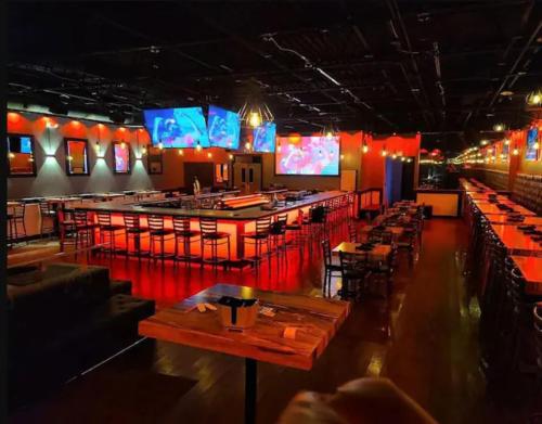 a restaurant with tables and a bar with red lights at Atlanta Unit 1 Room 3 - Cheerful Private Bedroom & Bathroom in Atlanta