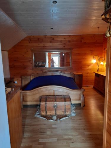 a bedroom with a bed in a wooden cabin at Pienińska Hawira in Kluszkowce