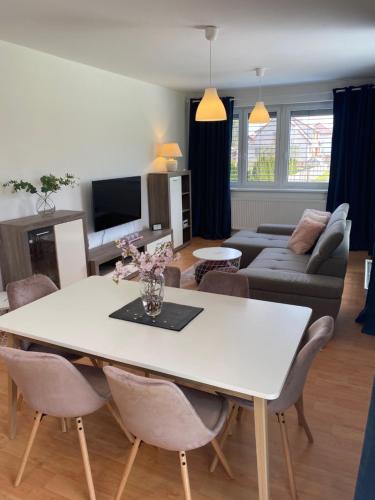 a living room with a white table and chairs at APARTMÁN LUŽNICE TŘEBOŇ in Třeboň
