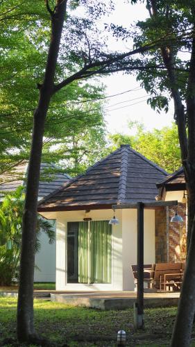 a small white house with a bench in a yard at Avare House Krabi in Ao Nam Mao