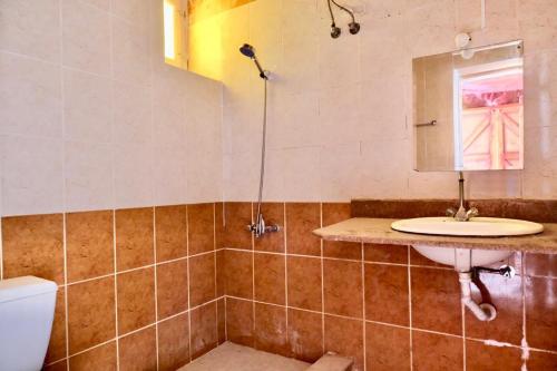 a bathroom with a sink and a toilet and a mirror at Bedouin Valley Eco Resort in Marsa Alam City