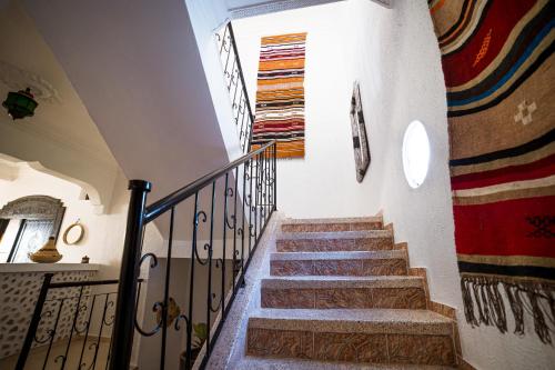 a staircase in a building with a stair railing at Original Surf Morocco in Tamraght Ouzdar