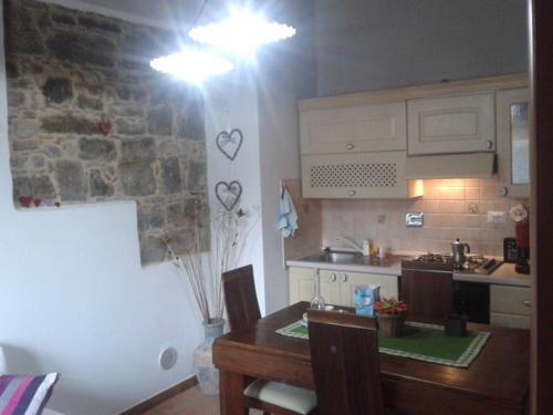 a kitchen with a table and a kitchen with hearts on the wall at Alloggio Agrituristico Conte Ottelio in Pradamano