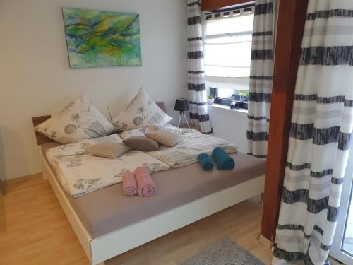 a bedroom with a bed with two pairs of slippers at Privat Apartaments , eigene Eigang, eigene Badezimmer, und eigene Küche in Straelen