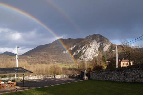 a rainbow in the sky with a mountain in the background at Vivienda vacacional Las Viñas in Oviedo