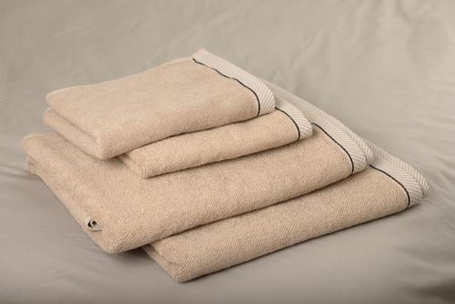 four towels stacked on top of a bed at Dominici 1-CahorsCityStay-Centre Clim Netflix in Cahors