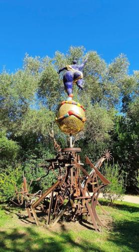 a statue of a bird sitting on top of a wooden structure at Casale Artemisia Capalbio in Capalbio