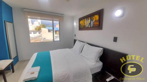 Ένα ή περισσότερα κρεβάτια σε δωμάτιο στο Hotel Centenario Plaza