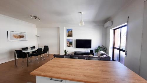 a living room with a couch and a table at Lovely 2-bedroom apartment - near Braga city center! in Braga