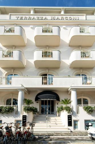 a building with bikes parked in front of it at Terrazza Marconi Hotel&Spamarine in Senigallia