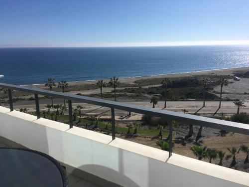 a view of the beach and the ocean from a balcony at SPECTACULAR APRT. IN FRONT OF THE SEA in Mojácar