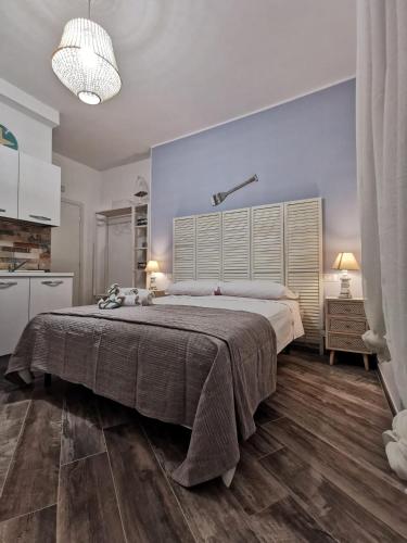 a large bedroom with a large bed and a blue wall at L' Ora Blu in Fiumicino