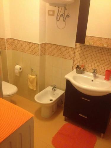 a bathroom with a sink and a toilet at Comodo appartamento a pochi metri dal mare in Bibione