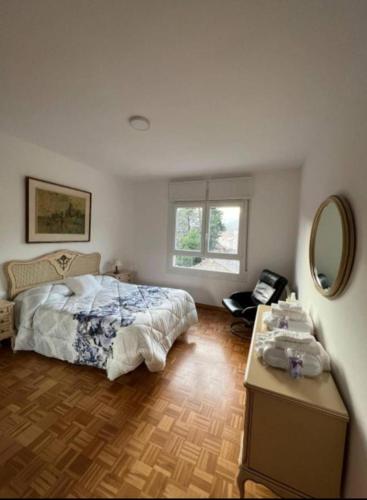 a bedroom with a bed and a table and a mirror at marsupilami in Pobla de Segur