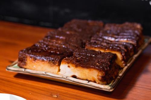 a group of ribs on a glass plate on a table at Villa 25 in Rio de Janeiro