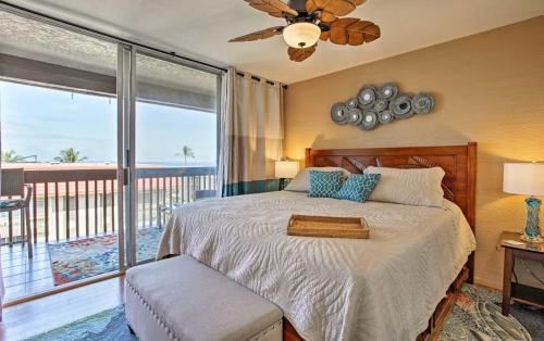 a bedroom with a bed with a view of the ocean at OCEAN VIEW 2 BEDROOM DOWNTOWN CONDO condo in Kailua-Kona