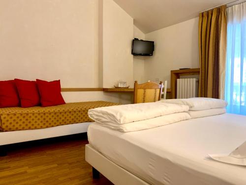 Ένα ή περισσότερα κρεβάτια σε δωμάτιο στο Hotel Berthod
