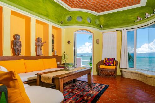 a living room with a couch and a table at Villas Jardin Del Mar in Cruz de Huanacaxtle