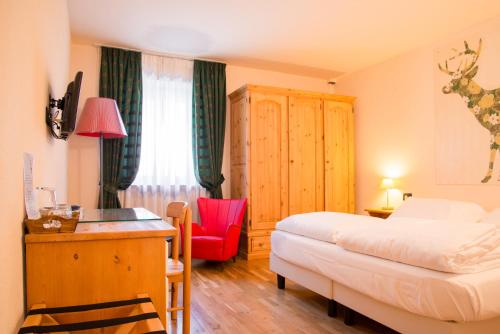 Ένα ή περισσότερα κρεβάτια σε δωμάτιο στο Hotel Berthod