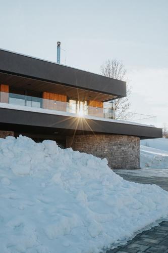 a pile of snow in front of a building at Downhills Residence in Zázrivá