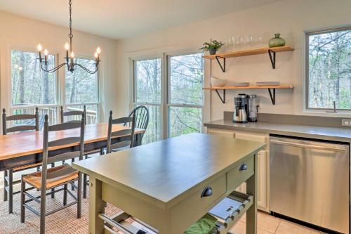 a kitchen and dining room with a table and chairs at Amazing A-Frame with Private Hiking and Amenities in Brevard