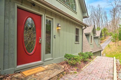 a red door on the side of a house at Amazing A-Frame with Private Hiking and Amenities in Brevard