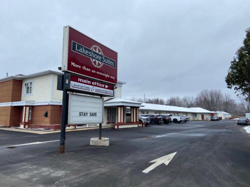 a sign in the parking lot of a car dealership at Lakeshore Suites in North Bay