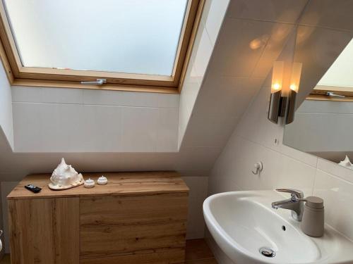 a bathroom with a sink and a mirror and a window at Frische Brise in Insel Poel