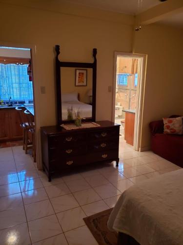 a bedroom with a dresser with a mirror on it at Cliffe Ranch in Mandeville