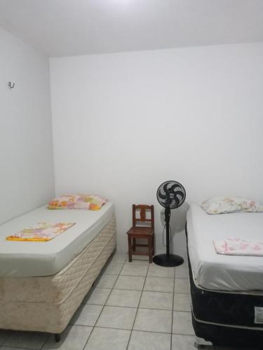 Cama ou camas em um quarto em Tropicália`s House