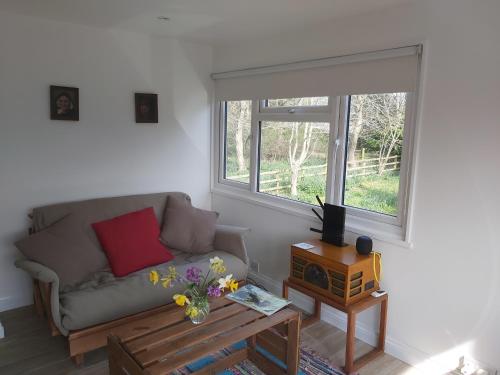 a living room with a couch and a window at Chauffeur's, Snape in Saxmundham