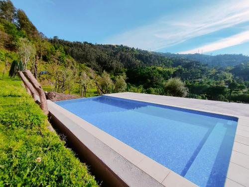 a swimming pool with a view of a mountain at Casa da Benda in Caniçada