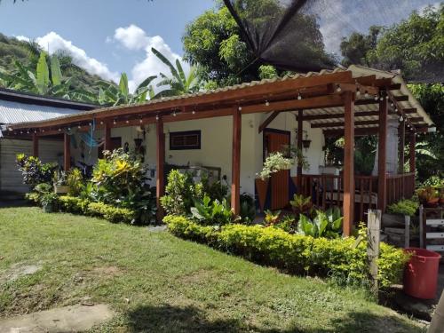 a house with a garden in front of it at Monteverde Holiday Apartments in Buga